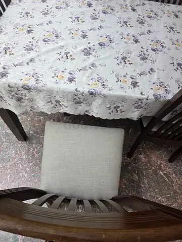 Wooden dining table with 6 upholstered chairs — good condition