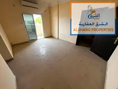 Two bedrooms and a living room, balcony, two bathrooms, split AC, Mina Street, easy access to Sharja