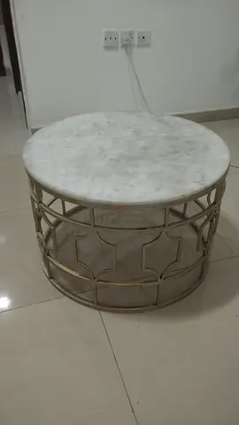 Round marble-top coffee table with gold metal base