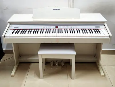 The Dynatone SLP-150 in white is a slim, space-saving digital piano featuring an 88-key weighted New