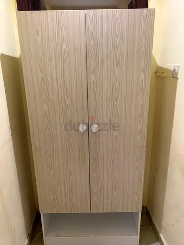 Two-door freestanding wardrobe with bottom shelf - light wood finish