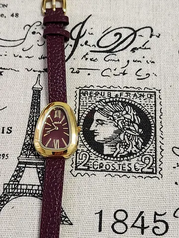 Women's gold-tone wristwatch with burgundy leather strap