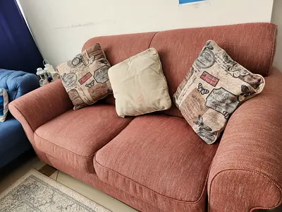 2-seater fabric sofa in coral with cushions - good condition
