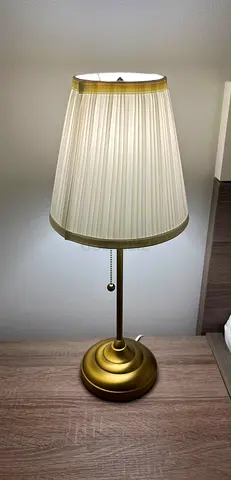Brass table lamp with pleated cream shade, working condition