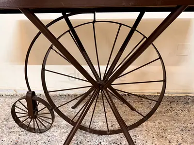 Vintage-style wooden trolley table with decorative wagon wheels