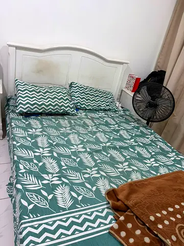 Queen bed frame with mattress and bedding - white wooden headboard