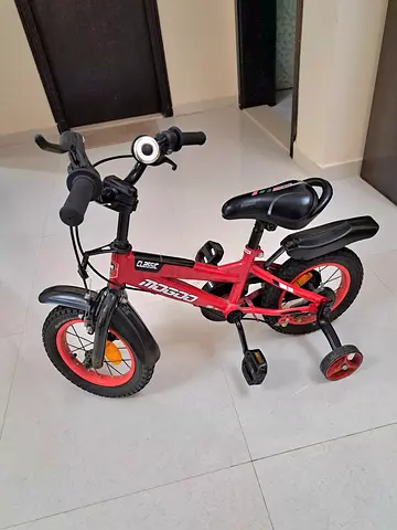 Kids red 12-inch bicycle with training wheels - good condition
