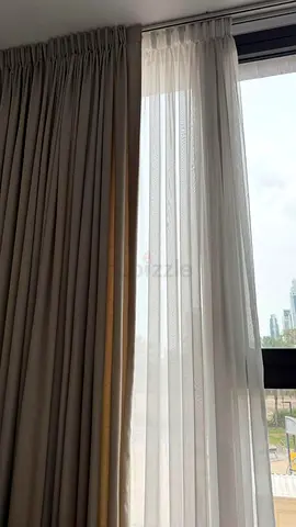 Beige curtains and white sheer curtains