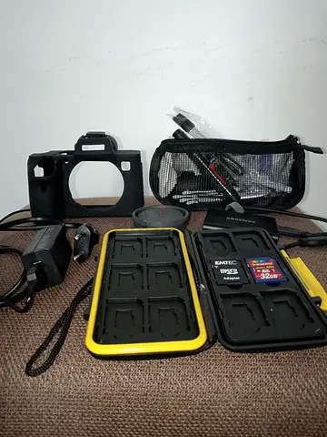 Camera accessories kit with SD cards, cases, charger and cables