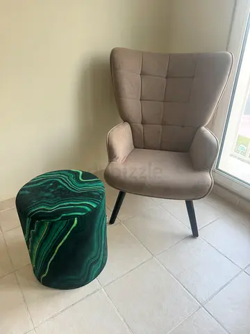 Beige tufted accent chair with green patterned ottoman - good condition