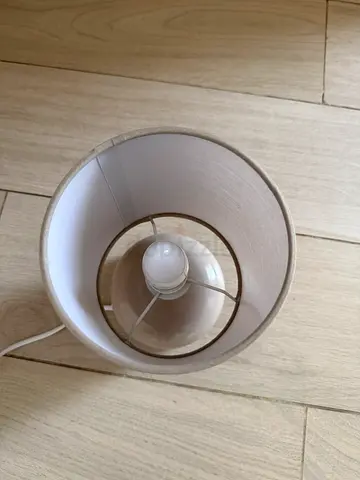 Simple beige table lamp with fabric shade and LED bulb