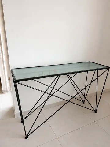 Slim grey metal console table with glass top - modern geometric frame