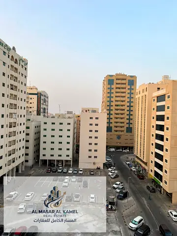 One-Bedroom Apartment for Annual Rent in Al Qasimia Al Mahatta Directly Opposite the Park with Balcony, Large Spaces, Distributor and One Free Month