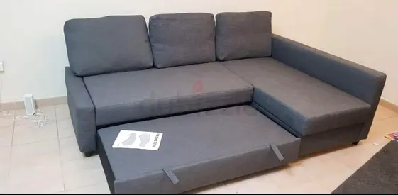 Used L-shaped fabric sofa with pull-out bed - grey