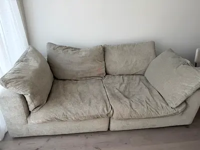 Two-seater light grey fabric sofa — good condition