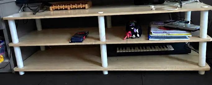Low-profile wooden TV stand with three open shelves