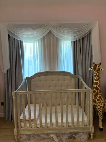 Wooden baby crib in light grey with mattress - gently used