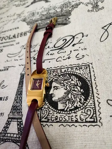 Small women's gold-tone rectangular wristwatch with leather strap