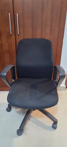 Used black swivel office chair with armrests — good condition