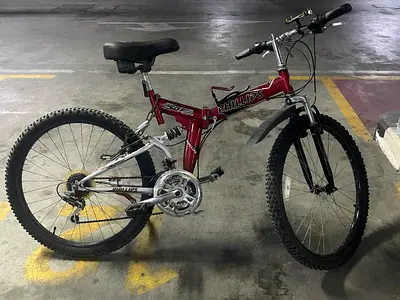 Red Phillips full-suspension mountain bike, 26-inch frame
