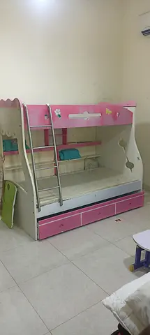 Pink wooden bunk bed with storage drawers — good condition