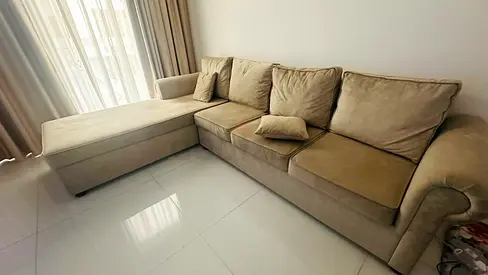 L-shaped beige fabric sofa with chaise - good condition