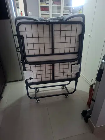 White folding bed with wheels