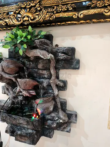 Wall-mounted indoor and outdoor decorative water fountain with LED lights and faux plants