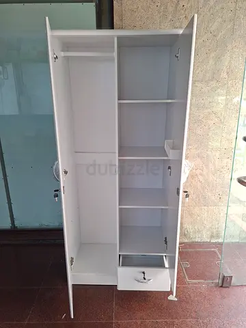 White tall wardrobe with multiple compartments and doors - good condition