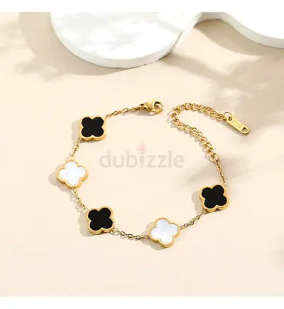 Gold-tone clover bracelet with black and white enamel inlays Designer inspired