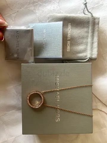 Michael Kors rose gold-tone circle pendant necklace with box, pouch, cloth, and cleaning booklet