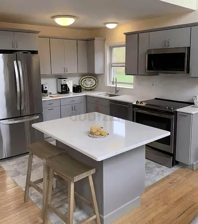 Modern grey kitchen w island and storage with marble