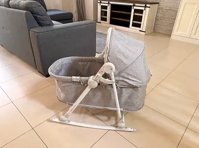 Light grey portable baby bassinet / rocker in good condition
