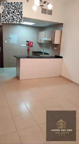1BR hall in City Towers Ajman with balcony and free parking; yearly rent AED 28,000 with 4 cheques