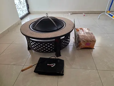 Outdoor metal fire pit with grill and cover — never been used