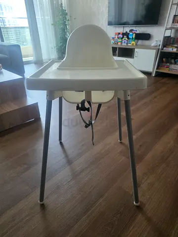 Simple white baby Ikea high chair with safety straps. Clean and ready to use.