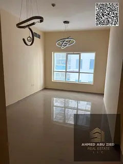 2BR hall in Pearl Tower Ajman, 940 sq ft, balcony, closed kitchen, 2 bathrooms, play area; yearly re