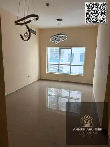 2BR hall in Pearl Tower Ajman, 940 sq ft, balcony, closed kitchen, 2 bathrooms, play area; yearly r