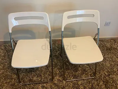 Pair of white folding chairs with metal frames - good condition