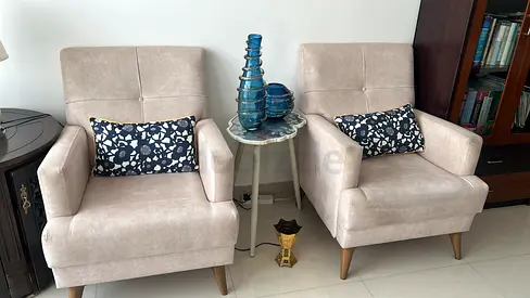 Pair of beige accent armchairs with cushions — good condition