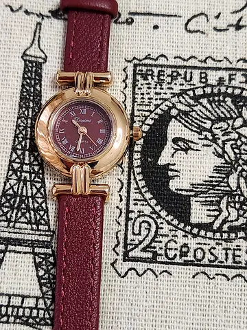 Vintage-style women's wristwatch with burgundy leather strap, working