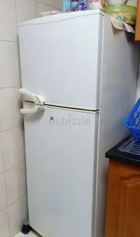 Used white top-freezer refrigerator - good working condition