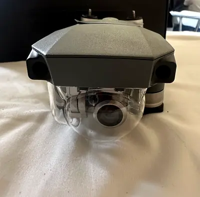 Used drone camera gimbal housing with lens (front view)