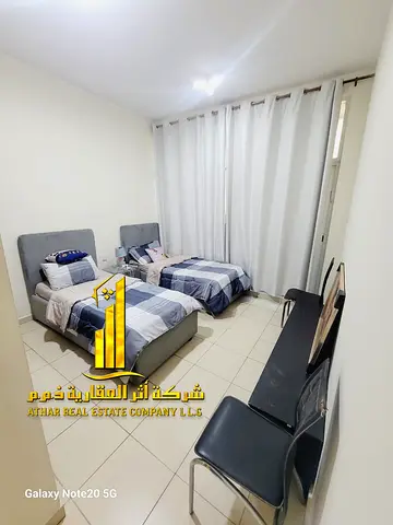 Luxurious two-bedroom apartment with a living room, fully furnished with brand new, high-end furniture, private parking, and a garden.