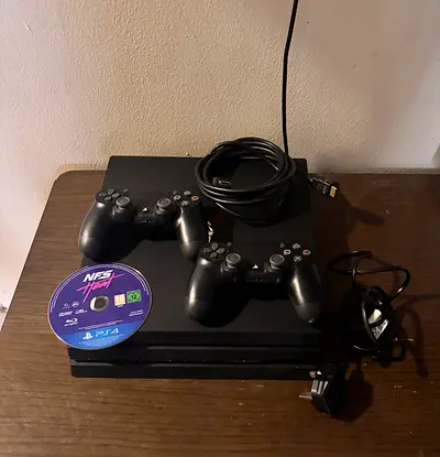 Sony PlayStation 4 Pro with 2 DualShock 4 Controllers and Need for Speed Disc