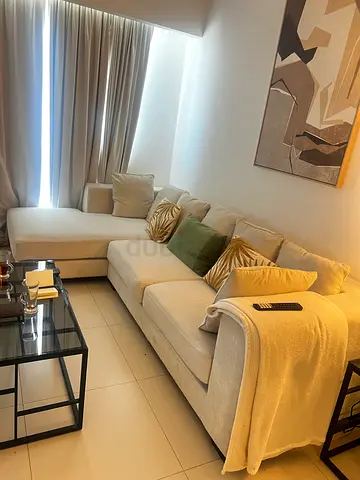 Light beige L-shaped fabric sofa with cushions (good condition)