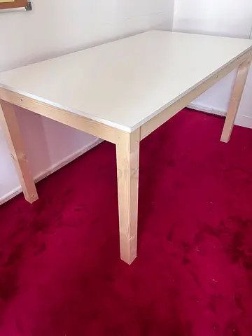 white dining or work table with wooden legs