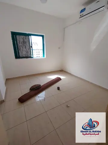 Spacious 2BR apartment in Al Qasimia Al Nad with balcony, prime strategic location near all services, family-friendly and easy road access.