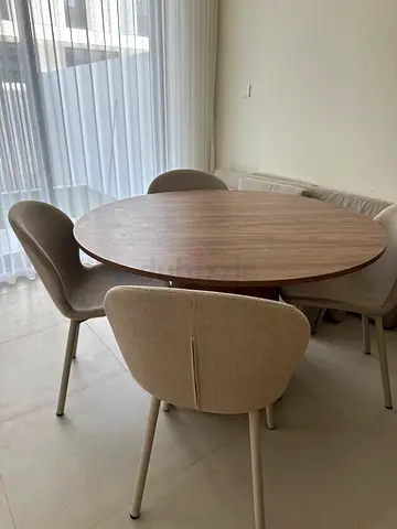 Round wooden dining table with 4 upholstered chairs - light beige