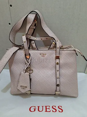 Light pink Guess tote handbag with studs and detachable charm